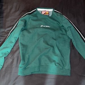 Long sleeve crew neck green sweater .